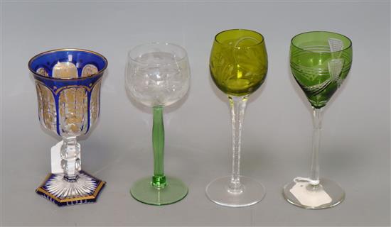 A 19th century Bohemian blue and gilt-decorated glass goblet on knopped stem and hexagonal foot and three hock glasses